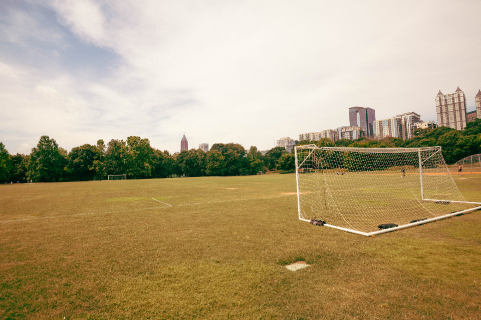 An open local playing field with a goal