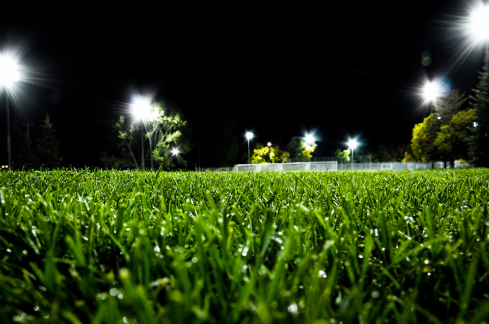 A community soccer match under stadium lights