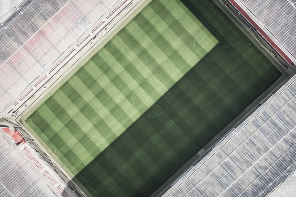 A green stadium field viewed from the stands